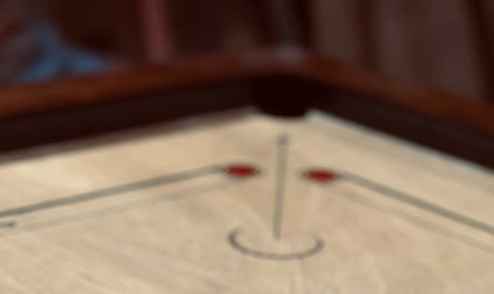 Close-up of a carrom board corner and pocket