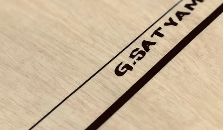 G.SATYAM name printed on a carrom board